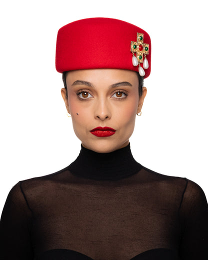 Red Pillbox Hat with Ornate Cross Brooch
