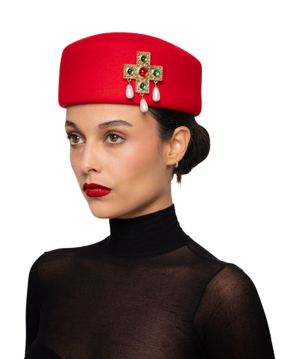 Red Pillbox Hat with Ornate Cross Brooch