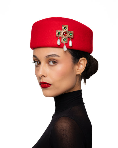 Red Pillbox Hat with Ornate Cross Brooch